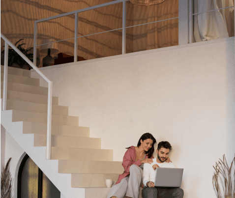 A modern house with a wooden staircase and large windows